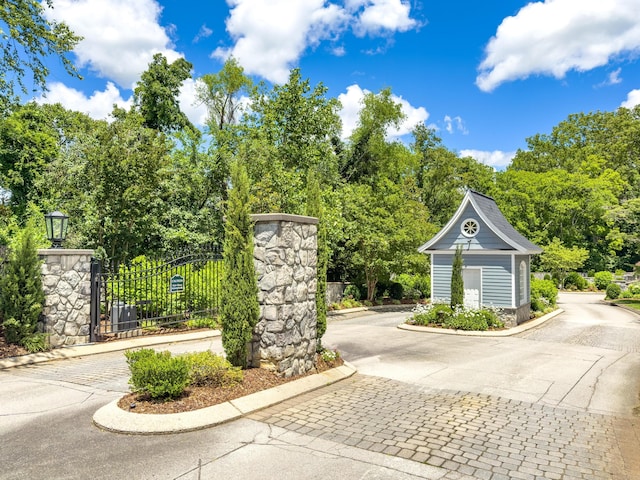 1676 Westover Ln, Chattanooga, TN 37405 - view of street featuring curbs, a gated entry, and view of wooded area