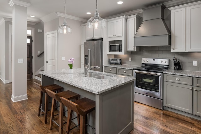 1676 Westover Ln, Chattanooga, TN 37405 - kitchen with appliances with stainless steel finishes, premium range hood, a sink, dark wood-style floors, and a kitchen island with sink