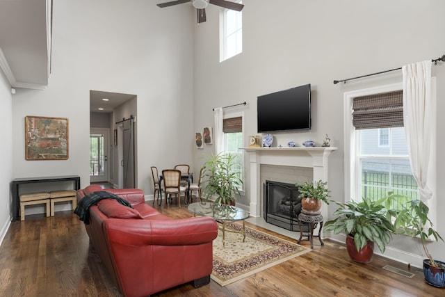 1676 Westover Ln, Chattanooga, TN 37405 - living room featuring a barn door, baseboards, wood finished floors, ceiling fan, and healthy amount of natural light
