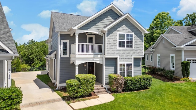 1676 Westover Ln, Chattanooga, TN 37405 - view of front of home with a balcony, a front lawn, and roof with shingles
