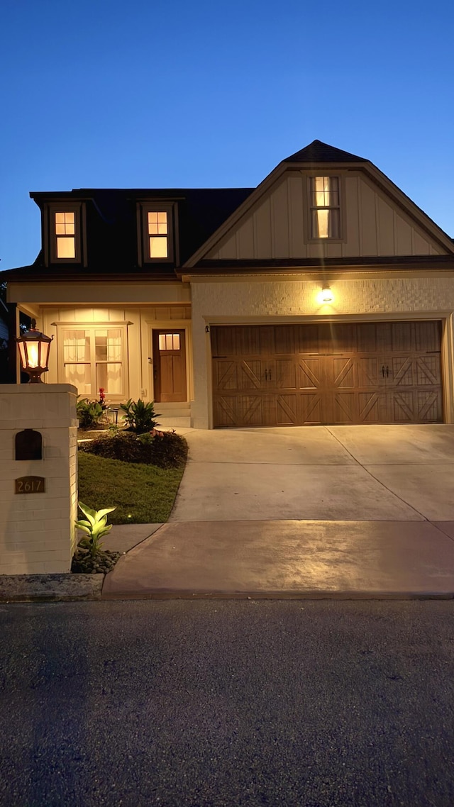 2617 Wendell Way, Chattanooga, TN 37421 - view of front of property with board and batten siding, driveway, and a garage