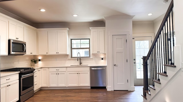2617 Wendell Way, Chattanooga, TN 37421 - kitchen with appliances with stainless steel finishes, decorative backsplash, light countertops, white cabinetry, and dark wood-type flooring