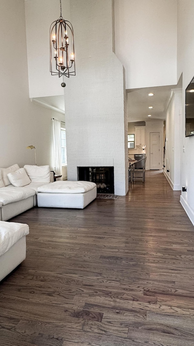 2617 Wendell Way, Chattanooga, TN 37421 - living area with a towering ceiling, a brick fireplace, dark wood-style floors, and a chandelier
