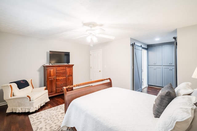 103 Paddle Wheel Ct, Cohutta, GA 30710 - bedroom featuring a barn door, dark wood-type flooring, and ceiling fan