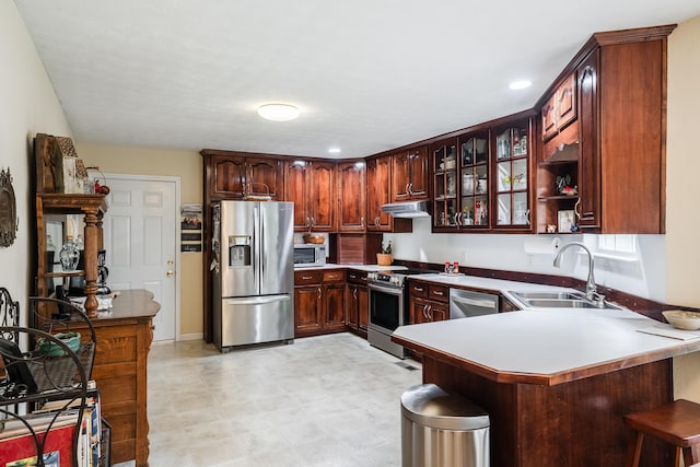 103 Paddle Wheel Ct, Cohutta, GA 30710 - kitchen with stainless steel appliances, a sink, a peninsula, a breakfast bar, and light flooring