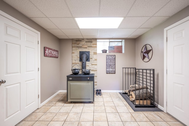 186 Mark Dr, Flintstone, GA 30725 - home office with a drop ceiling, light tile patterned floors, and a wood stove