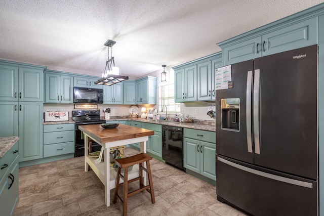 186 Mark Dr, Flintstone, GA 30725 - kitchen featuring black appliances, pendant lighting, a textured ceiling, butcher block counters, and blue cabinetry