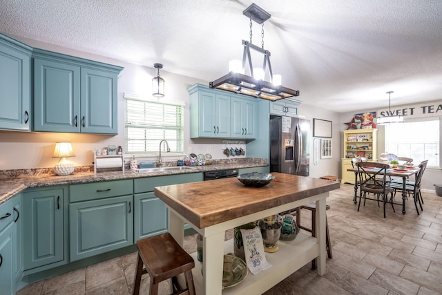 186 Mark Dr, Flintstone, GA 30725 - kitchen with stainless steel fridge with ice dispenser, blue cabinetry, a textured ceiling, pendant lighting, and black dishwasher