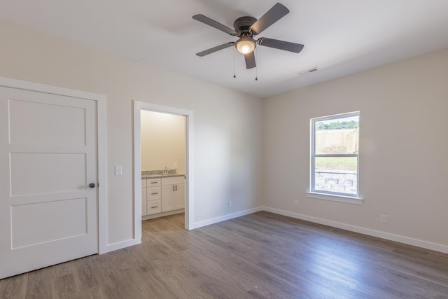 4327 Cronan Dr, Cohutta, GA 30710 - unfurnished bedroom with light wood-style flooring, connected bathroom, and a ceiling fan