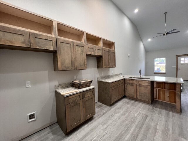 35 Avery Ln Unit 3, Ringgold, GA 30736 - kitchen with vaulted ceiling, a sink, open shelves, a peninsula, and light wood finished floors