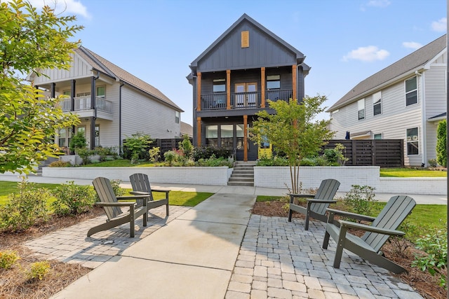 1531 Bowtie Rd, Chattanooga, TN 37421 - back of house with board and batten siding, a balcony, a patio area, and stairs
