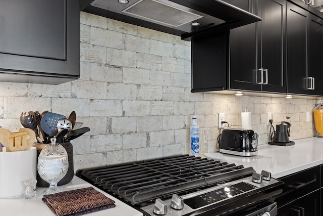 1531 Bowtie Rd, Chattanooga, TN 37421 - kitchen with dark cabinets, stainless steel gas range oven, light countertops, and tasteful backsplash
