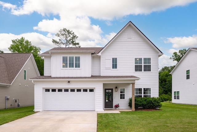 1269 Baldwin Field Cir, Hixson, TN 37343 - view of front facade featuring board and batten siding, concrete driveway, a garage, and a front yard