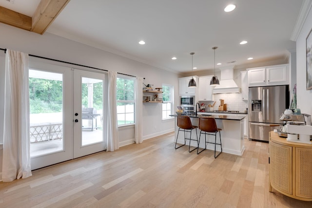 1269 Baldwin Field Cir, Hixson, TN 37343 - kitchen with stainless steel appliances, custom range hood, french doors, light wood-type flooring, and backsplash