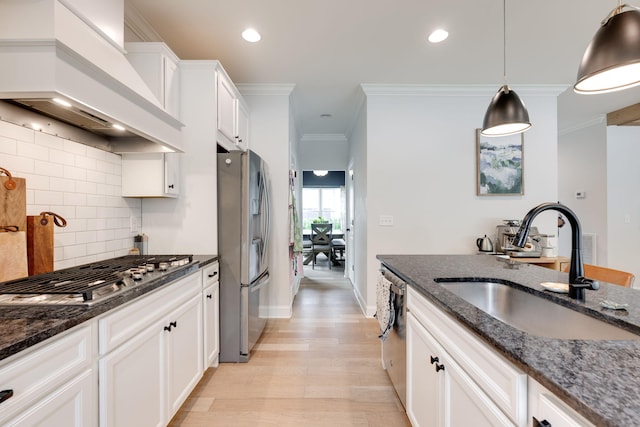 1269 Baldwin Field Cir, Hixson, TN 37343 - kitchen with appliances with stainless steel finishes, custom exhaust hood, a sink, light wood finished floors, and decorative backsplash