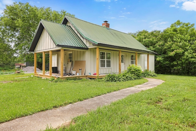 760 Keith Rd SE, Dalton, GA 30721 - view of front of property with covered porch, board and batten siding, a front yard, and a chimney