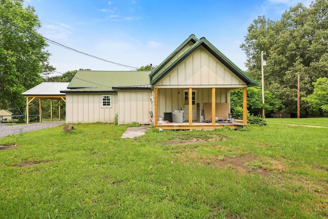 760 Keith Rd SE, Dalton, GA 30721 - back of house featuring board and batten siding, driveway, a lawn, a porch, and metal roof