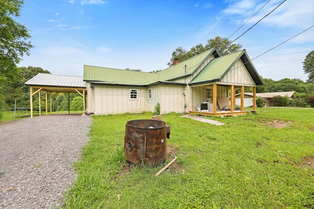 760 Keith Rd SE, Dalton, GA 30721 - view of front of home featuring board and batten siding, a front yard, metal roof, and a carport