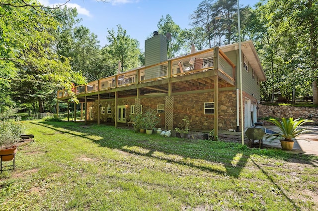 204 Chapman Ct, Lafayette, GA 30728 - back of property featuring a lawn, a garage, a wooden deck, stone siding, and a chimney