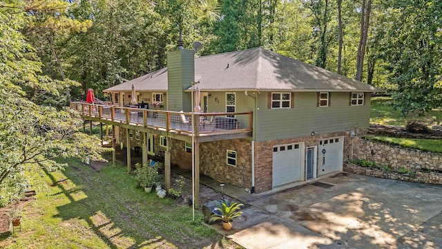 204 Chapman Ct, Lafayette, GA 30728 - back of property featuring a chimney, a shingled roof, an attached garage, a deck, and driveway