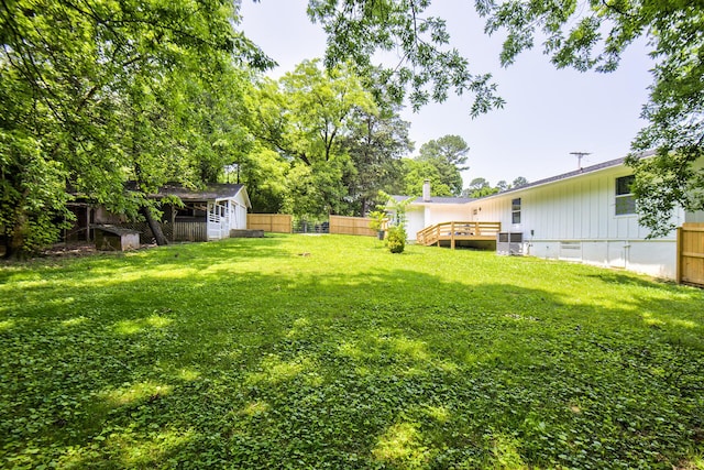 717 W James St, Rossville, GA 30741 - view of yard featuring a deck, central AC unit, and an outbuilding