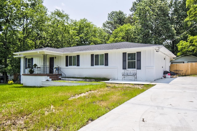 717 W James St, Rossville, GA 30741 - view of front of house with board and batten siding, covered porch, roof with shingles, and brick siding