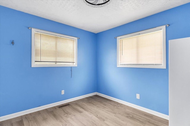 536 Sequatchie Ln, Sequatchie, TN 37374 - empty room with wood finished floors, baseboards, and a textured ceiling