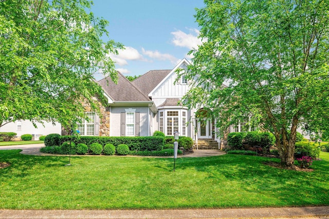 902 Cattails Dr, Ooltewah, TN 37363 - view of front of home featuring a front lawn, board and batten siding, stone siding, and a shingled roof