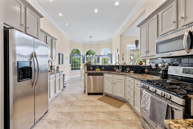 902 Cattails Dr, Ooltewah, TN 37363 - kitchen featuring appliances with stainless steel finishes, a peninsula, a sink, dark stone counters, and backsplash
