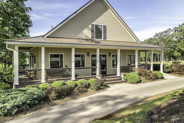 902 Cattails Dr, Ooltewah, TN 37363 - farmhouse-style home with covered porch, metal roof, and a standing seam roof