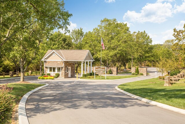 902 Cattails Dr, Ooltewah, TN 37363 - view of home's community featuring asphalt driveway, a yard, and view of scattered trees