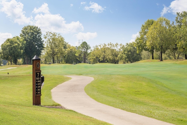 902 Cattails Dr, Ooltewah, TN 37363 - surrounding community with view of golf course, view of wooded area, a lawn, and driveway