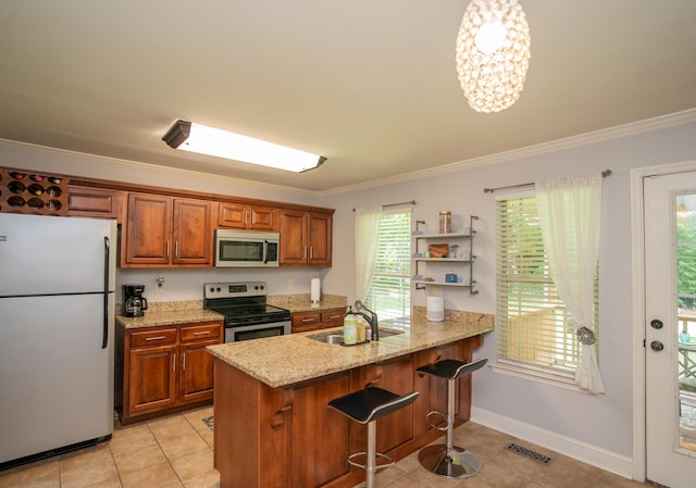 3613 Altamira Dr, Chattanooga, TN 37412 - kitchen featuring stainless steel appliances, brown cabinets, ornamental molding, and light tile patterned floors