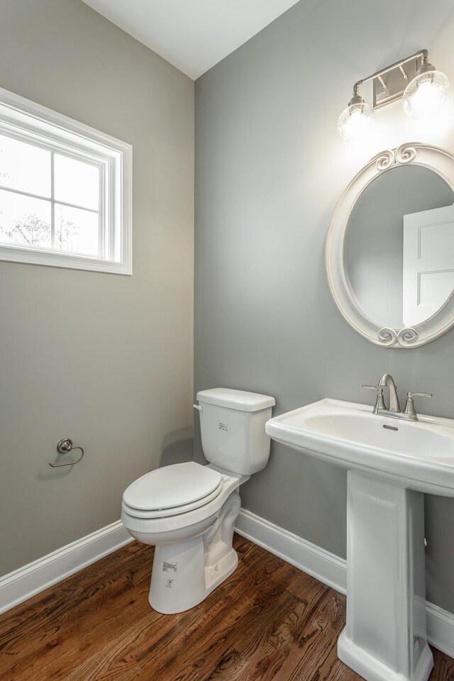 1811 Oakvale Dr, Chattanooga, TN 37421 - bathroom featuring wood finished floors, toilet, baseboards, and a sink