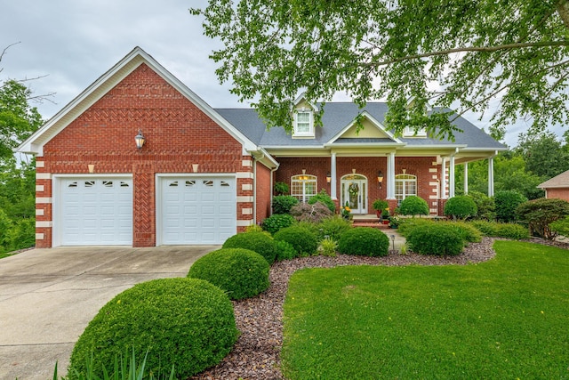 9548 Shadow Crossing Ln, Chattanooga, TN 37421 - view of front facade featuring brick siding, concrete driveway, a garage, a front yard, and covered porch