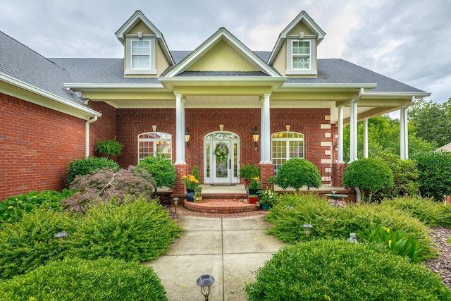 9548 Shadow Crossing Ln, Chattanooga, TN 37421 - property entrance featuring a porch, brick siding, and roof with shingles