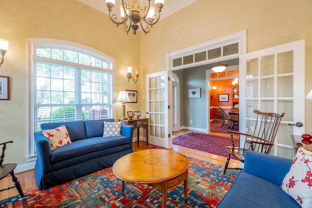 9548 Shadow Crossing Ln, Chattanooga, TN 37421 - living room featuring french doors, wood finished floors, a chandelier, ornamental molding, and baseboards