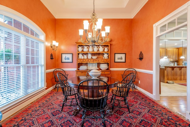 9548 Shadow Crossing Ln, Chattanooga, TN 37421 - dining space with a chandelier, wood finished floors, crown molding, a towering ceiling, and a tray ceiling