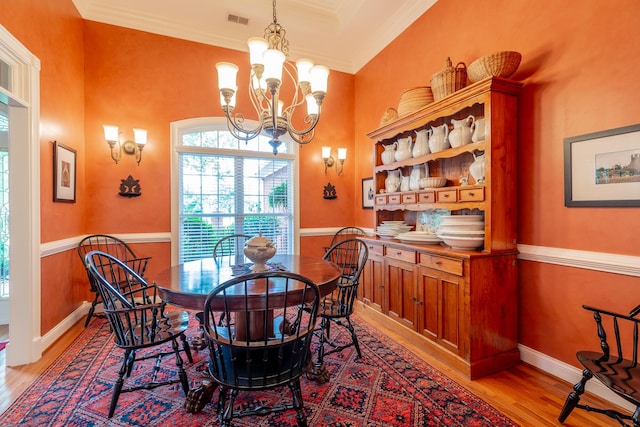 9548 Shadow Crossing Ln, Chattanooga, TN 37421 - dining room with wood finished floors, a chandelier, crown molding, a towering ceiling, and a wainscoted wall