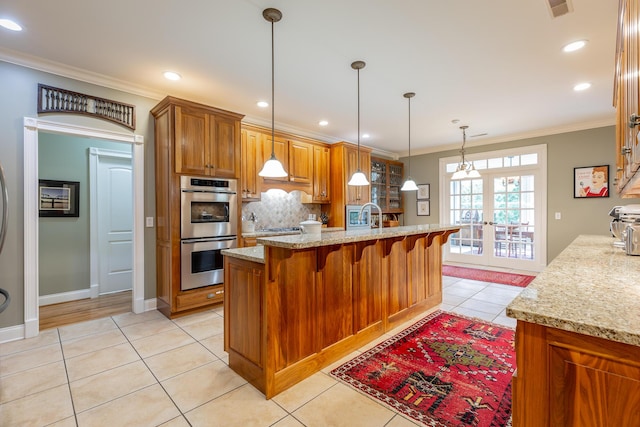 9548 Shadow Crossing Ln, Chattanooga, TN 37421 - kitchen featuring stainless steel appliances, light tile patterned floors, decorative backsplash, ornamental molding, and brown cabinetry