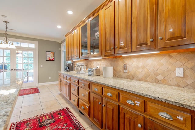 9548 Shadow Crossing Ln, Chattanooga, TN 37421 - kitchen with ornamental molding, brown cabinetry, baseboards, backsplash, and decorative light fixtures