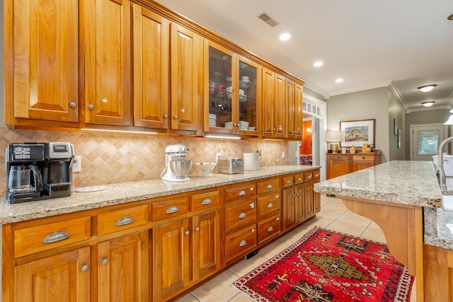 9548 Shadow Crossing Ln, Chattanooga, TN 37421 - kitchen with crown molding, light tile patterned floors, decorative backsplash, and brown cabinetry