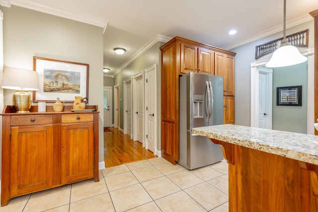 9548 Shadow Crossing Ln, Chattanooga, TN 37421 - kitchen featuring stainless steel fridge, ornamental molding, light tile patterned floors, brown cabinets, and pendant lighting