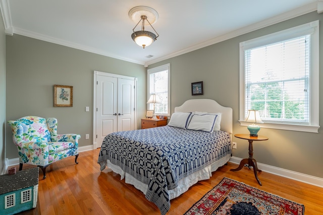 9548 Shadow Crossing Ln, Chattanooga, TN 37421 - bedroom featuring wood finished floors, multiple windows, a closet, ornamental molding, and baseboards