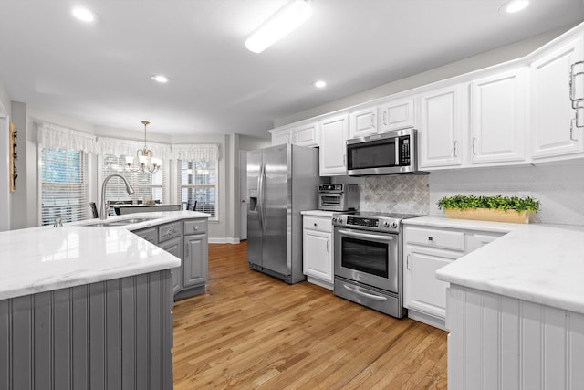 102 Water Mill Trce, Ringgold, GA 30736 - kitchen with stainless steel appliances, light wood-type flooring, white cabinetry, and recessed lighting