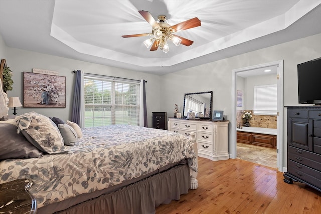 102 Water Mill Trce, Ringgold, GA 30736 - bedroom featuring a raised ceiling, light wood-type flooring, connected bathroom, and ceiling fan