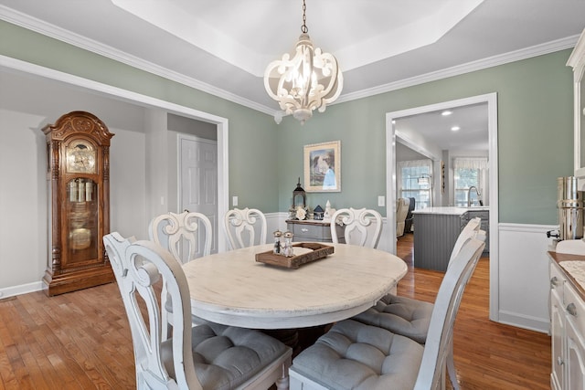 102 Water Mill Trce, Ringgold, GA 30736 - dining area featuring light wood-style flooring, a chandelier, ornamental molding, and a raised ceiling