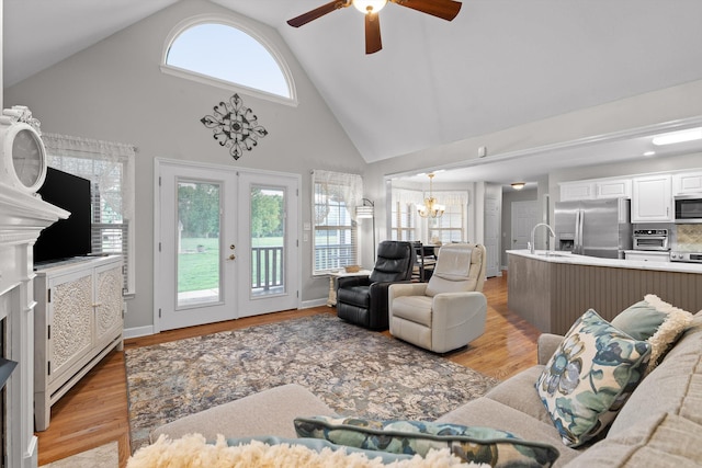102 Water Mill Trce, Ringgold, GA 30736 - living area featuring high vaulted ceiling, ceiling fan, a chandelier, light wood-style flooring, and french doors