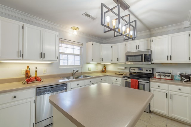 1625 Lisa Lynn Dr, Hixson, TN 37343 - kitchen with appliances with stainless steel finishes, white cabinetry, a chandelier, crown molding, and hanging light fixtures
