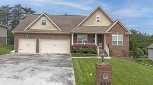9704 Starry Way, Soddy Daisy, TN 37379 - view of front of house featuring driveway, a front yard, a garage, and covered porch